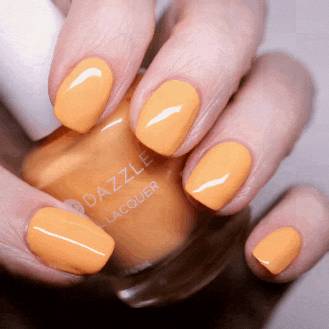 Hand Holding Mini Size Creamsicle Painted on the nails