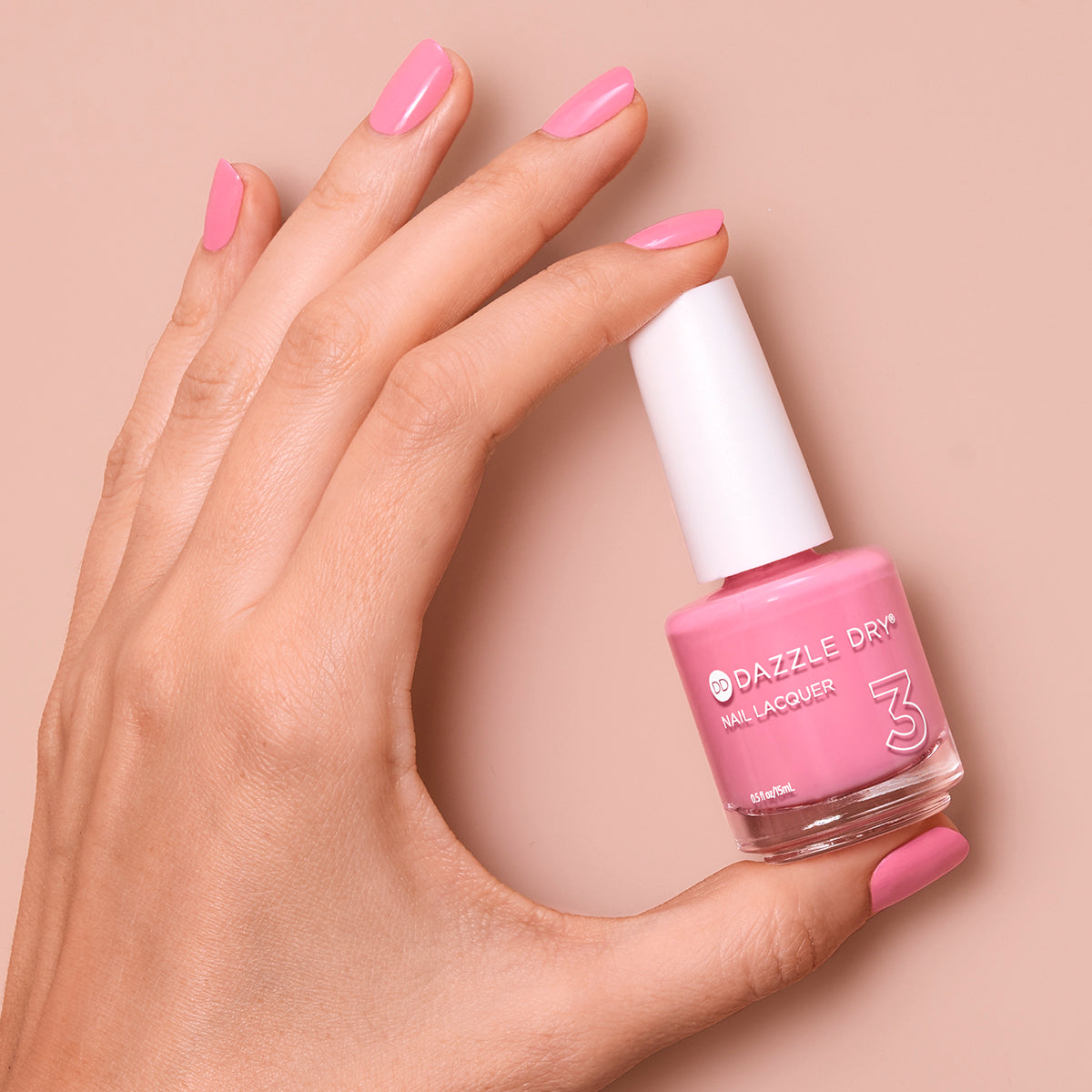 Hand with Soulmate painted on nails holding lacquer bottle