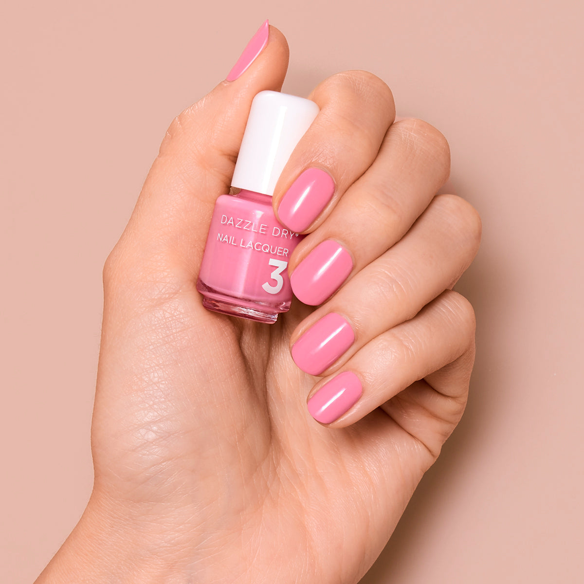 Hand with Soulmate painted on nails holding mini lacquer bottle