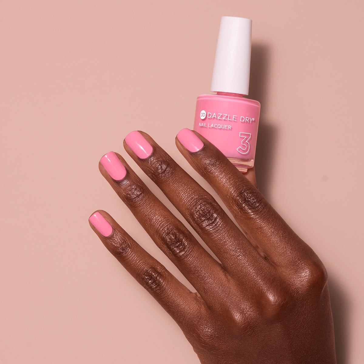 Hand with Soulmate painted on nails holding lacquer bottle