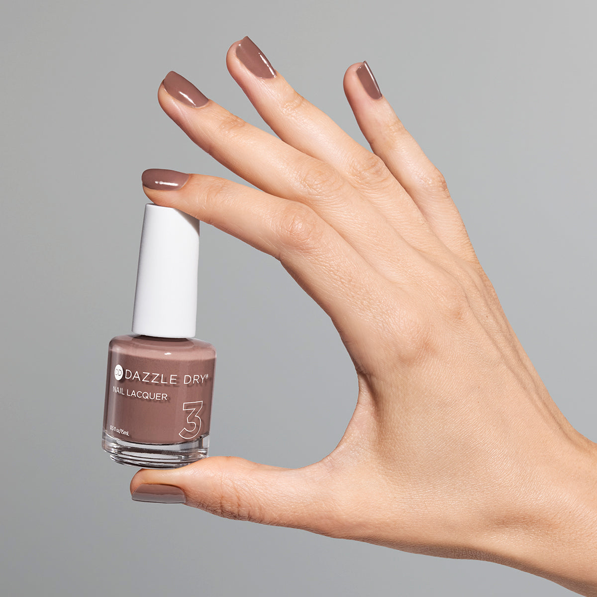 Hand with Your Nails, But Better painted on nails holding full size lacquer bottle