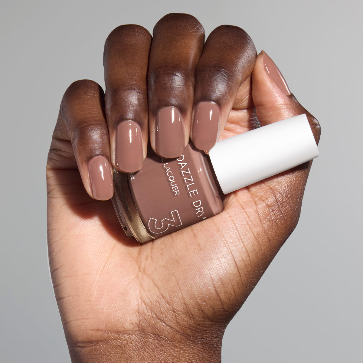 Hand with Your Nails, But Better painted on nails holding full size lacquer bottle
