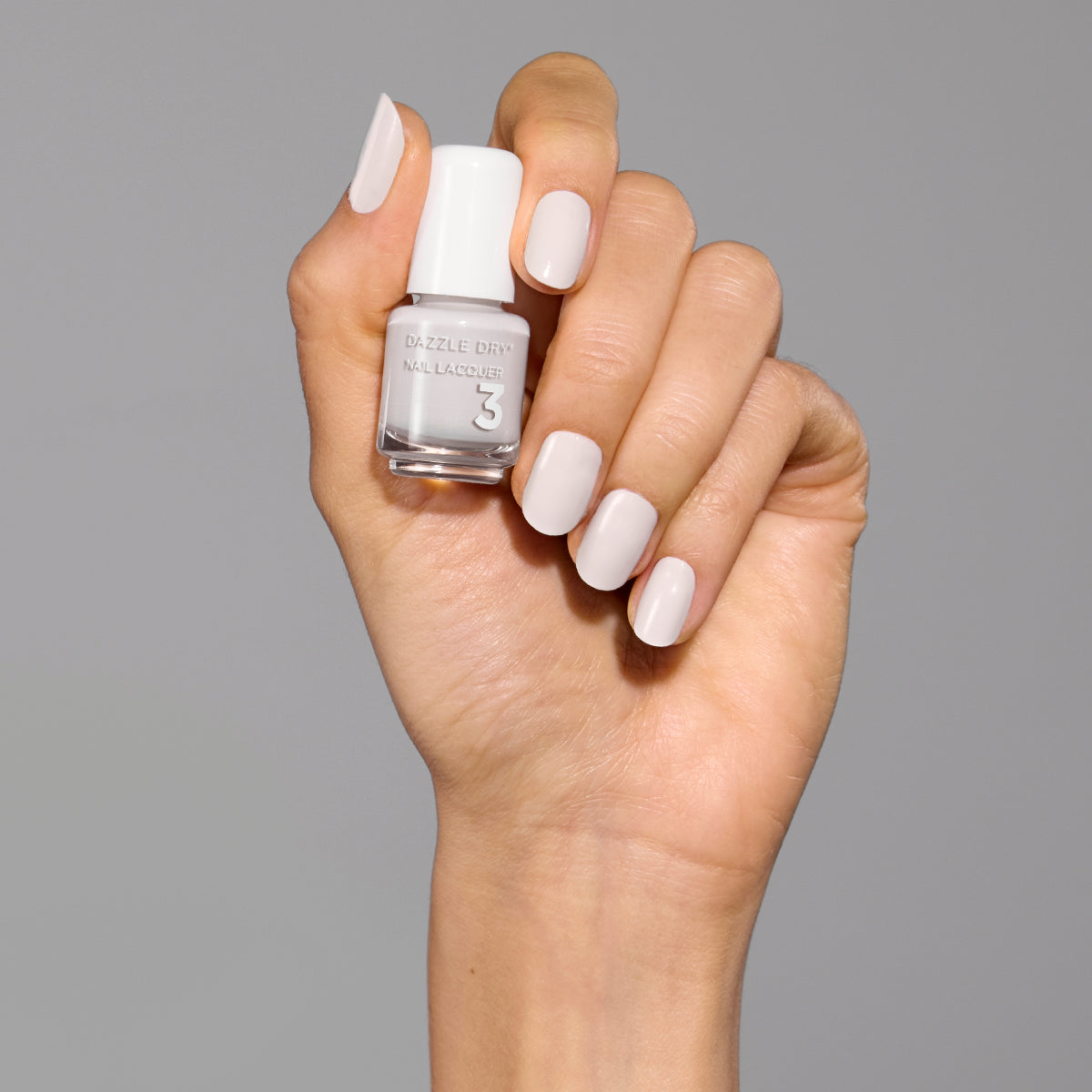 Hand with A Clean Slate painted on fingernails holding mini nail polish bottle