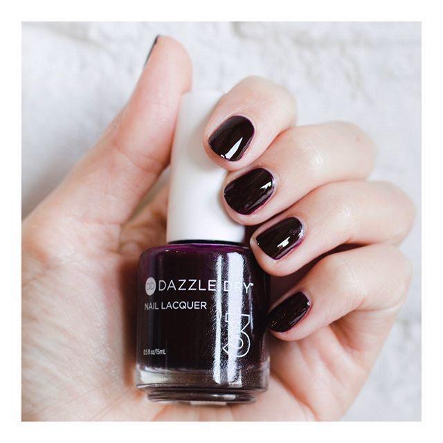 Hand with Forbidden Passion painted on nails holding lacquer bottle