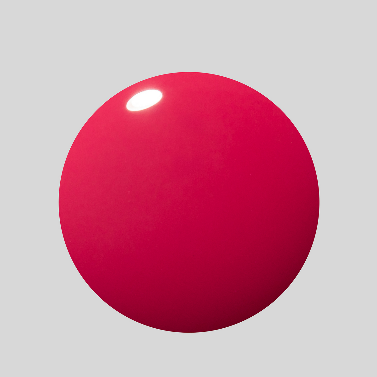 A glossy, spherical red object with a soft shadow on a solid light gray background.