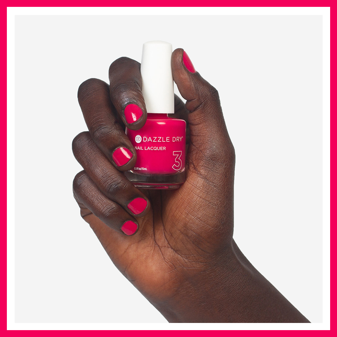 Hand with Fantasy painted on nails holding lacquer bottle