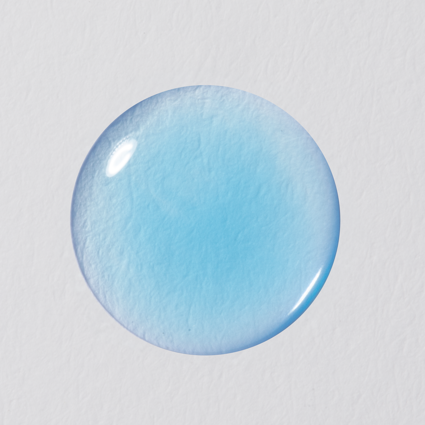 Blue circular object on a light gray background