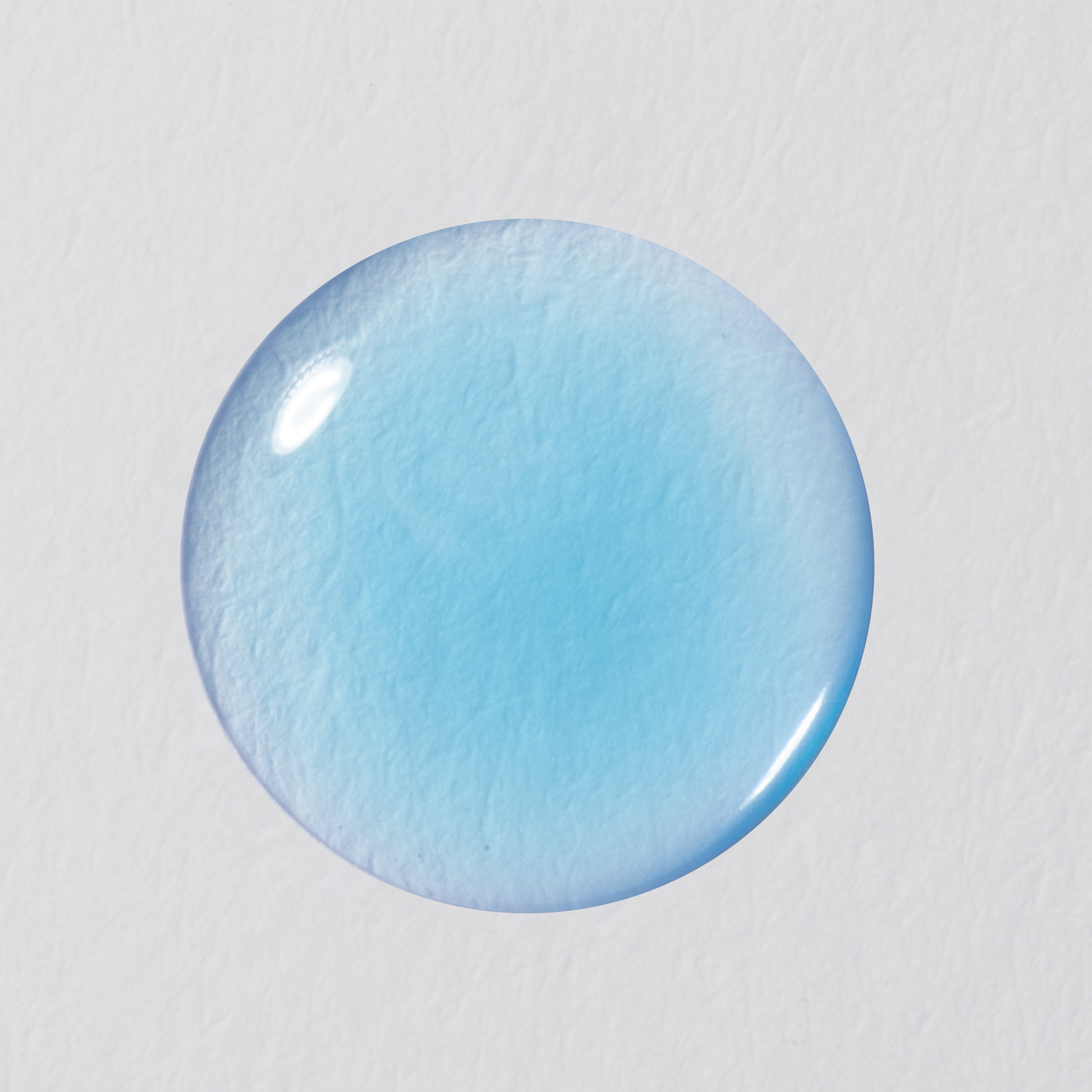 Blue circular object on a light gray background