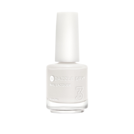 A bottle of Dazzle Dry Nail Lacquer in a solid off-white shade, featuring a white cap and clear glass bottle on a plain white background.