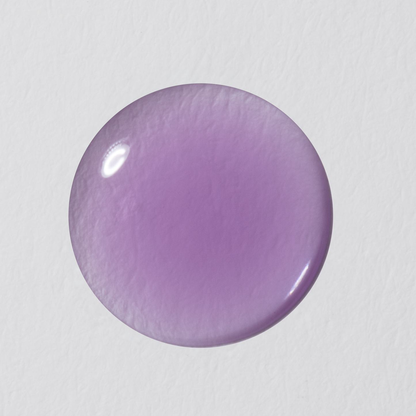Round purple object on a light gray background