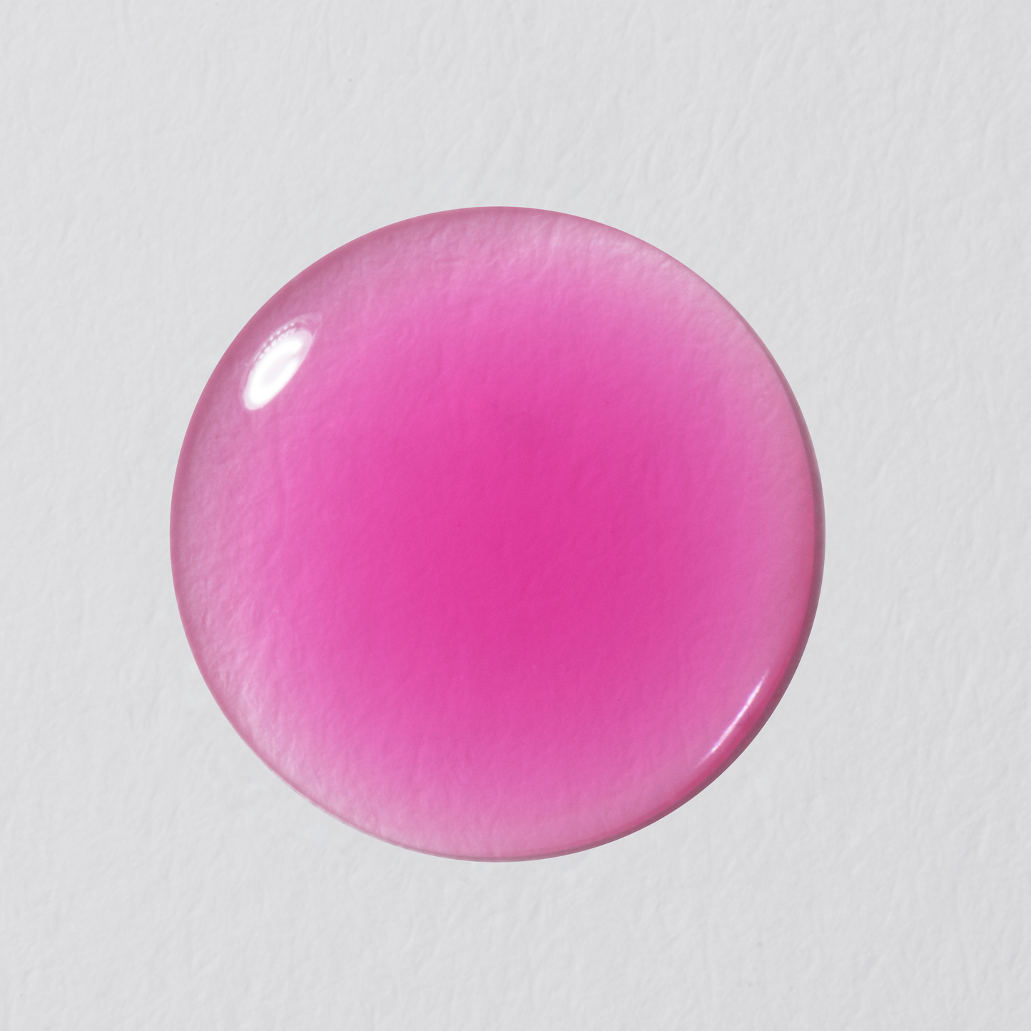 Pink round object on a light gray background
