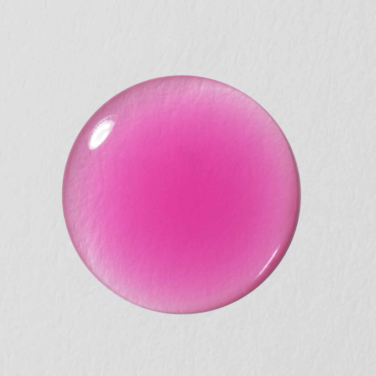 Pink round object on a light gray background
