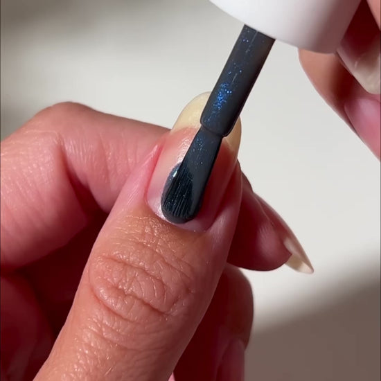 video of blue nail polish painted onto nail
