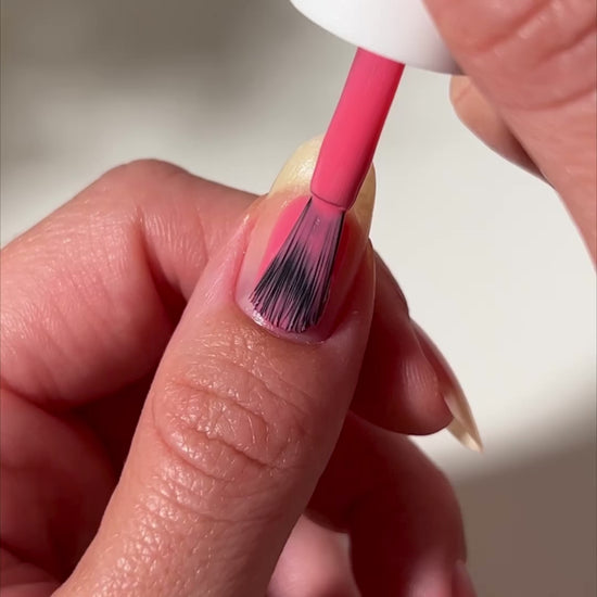 video of pink nail polish applied to nail
