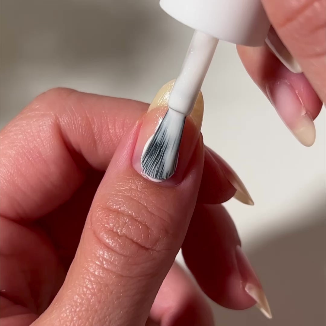 video of white polish applied to nail